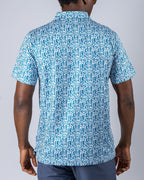 Men’s Maze Craze golf polo by Pins & Aces featuring an all-over blue maze-inspired geometric pattern with short sleeves and an athletic performance fit.