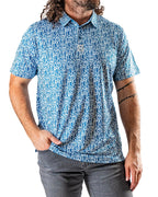 Men’s Maze Craze golf polo by Pins & Aces featuring an all-over blue maze-inspired geometric pattern with short sleeves and an athletic performance fit.