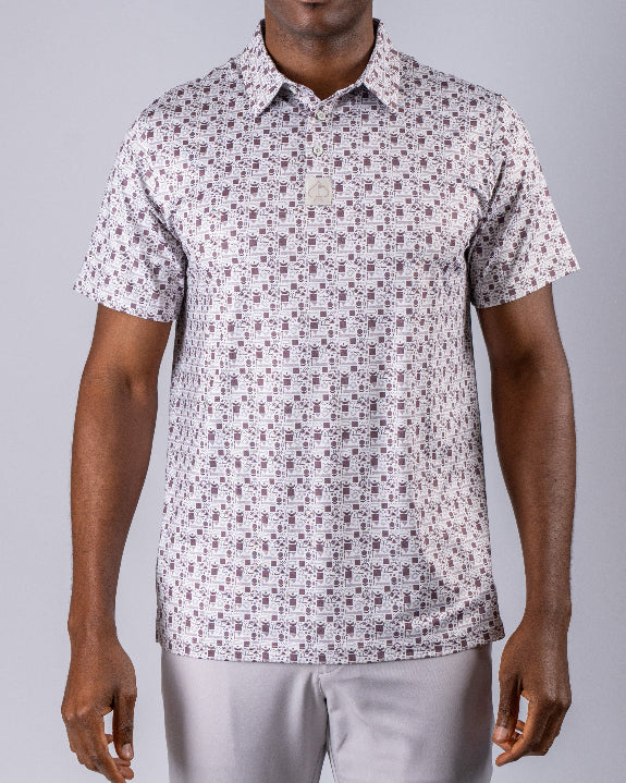 Men’s Retro Form golf polo by Pins & Aces featuring a vintage-inspired geometric print in neutral tones with burgundy accents, short sleeves, and an athletic fit.