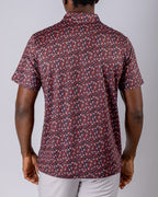 Men’s Shadow Rose golf polo by Pins & Aces featuring an all-over red and muted rose floral print on a black background with short sleeves and an athletic performance fit.