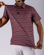 Men’s Shadow Rose golf polo by Pins & Aces featuring an all-over red and muted rose floral print on a black background with short sleeves and an athletic performance fit.