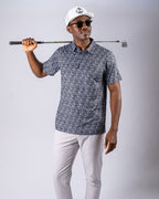 Men’s Shark Tooth golf polo by Pins & Aces featuring an all-over black, charcoal, gray, and white shark tooth-inspired micro print with short sleeves and an athletic performance fit.