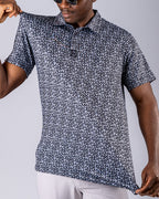 Men’s Shark Tooth golf polo by Pins & Aces featuring an all-over black, charcoal, gray, and white shark tooth-inspired micro print with short sleeves and an athletic performance fit.