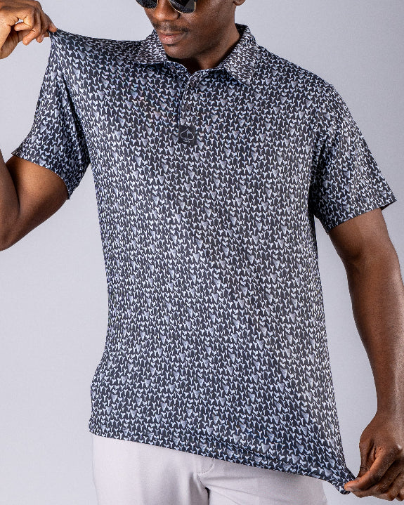 Men’s Shark Tooth golf polo by Pins & Aces featuring an all-over black, charcoal, gray, and white shark tooth-inspired micro print with short sleeves and an athletic performance fit.