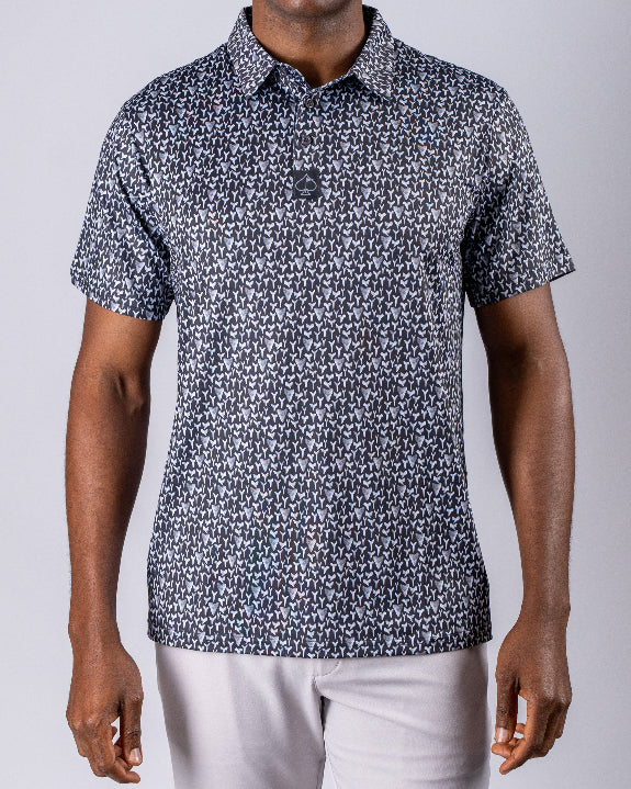 Men’s Shark Tooth golf polo by Pins & Aces featuring an all-over black, charcoal, gray, and white shark tooth-inspired micro print with short sleeves and an athletic performance fit.