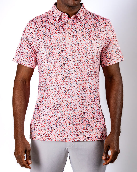 Men’s Soft Spoken golf polo by Pins & Aces featuring a subtle coral, red, navy, and white micro floral print with short sleeves and an athletic performance fit.