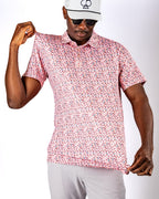 Men’s Soft Spoken golf polo by Pins & Aces featuring a subtle coral, red, navy, and white micro floral print with short sleeves and an athletic performance fit.