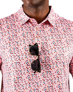 Men’s Soft Spoken golf polo by Pins & Aces featuring a subtle coral, red, navy, and white micro floral print with short sleeves and an athletic performance fit.