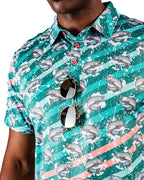 Men’s Trout Splatter golf polo by Pins & Aces featuring an all-over trout fishing print with teal, aqua, coral, and white splatter details and an athletic performance fit.