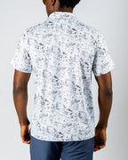 Men’s White Noise golf polo by Pins & Aces featuring a subtle white and gray abstract pattern, short sleeves, and an athletic performance fit.