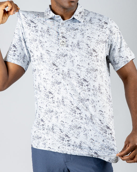 Men’s White Noise golf polo by Pins & Aces featuring a subtle white and gray abstract pattern, short sleeves, and an athletic performance fit.