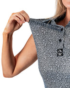 Pins & Aces Women’s Coral Cascades performance golf polo featuring a women’s athletic fit with fast-wicking fabric, SPF 45+ protection and a built-in sunglasses holder.