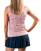 Women’s Soft Spoken golf polo by Pins & Aces featuring a sleeveless collared design with an all-over coral, pink, gray, and black micro floral print and athletic performance fit.