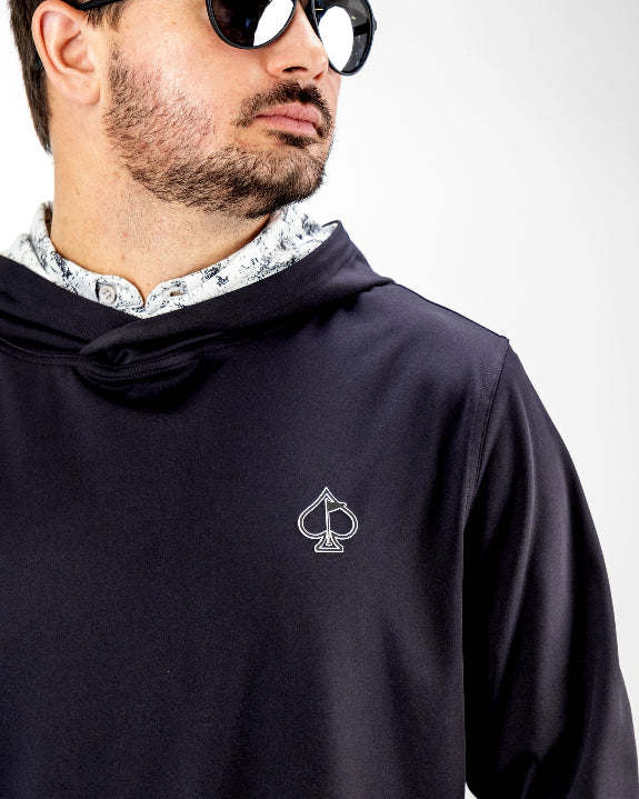 Men’s White Noise Performance Golf Hoodie by Pins & Aces featuring a black lightweight stretch body, embroidered spade chest logo, long sleeves, and White Noise printed hood lining.