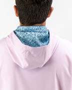 Men’s Flower Doodle Blue performance golf hoodie by Pins & Aces featuring a light pink body, blue floral doodle printed hood interior, embroidered spade logo, and long sleeves.
