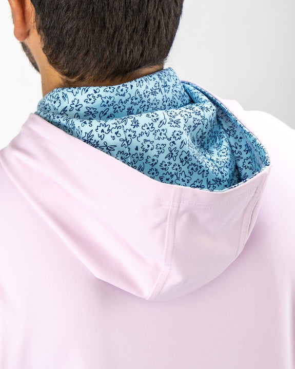 Men’s Flower Doodle Blue performance golf hoodie by Pins & Aces featuring a light pink body, blue floral doodle printed hood interior, embroidered spade logo, and long sleeves.