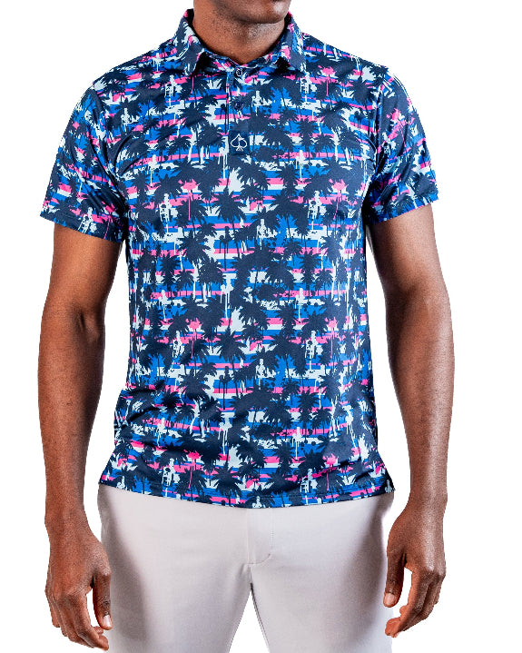 Men’s Palm Drip Dawn golf polo by Pins & Aces featuring navy palm trees over a blue, pink, and white tropical print with short sleeves and an athletic performance fit.