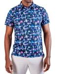 Men’s Palm Drip Dawn golf polo by Pins & Aces featuring navy palm trees over a blue, pink, and white tropical print with short sleeves and an athletic performance fit.