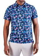 Men’s Palm Drip Dawn golf polo by Pins & Aces featuring navy palm trees over a blue, pink, and white tropical print with short sleeves and an athletic performance fit.