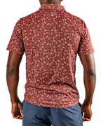 Men’s Autumn Bloom golf polo by Pins & Aces featuring a rust-colored all-over cream floral print, short sleeves, blade collar, and athletic performance fit.