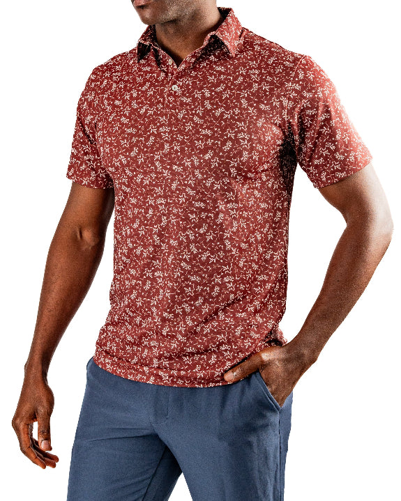 Men’s Autumn Bloom golf polo by Pins & Aces featuring a rust-colored all-over cream floral print, short sleeves, blade collar, and athletic performance fit.