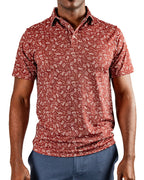 Men’s Autumn Bloom golf polo by Pins & Aces featuring a rust-colored all-over cream floral print, short sleeves, blade collar, and athletic performance fit.