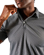 Men’s Jade Drops golf polo by Pins & Aces featuring a dark jade green geometric pattern, modern blade collar, short sleeves, and athletic performance fit.
