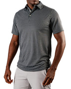Men’s Jade Drops golf polo by Pins & Aces featuring a dark jade green geometric pattern, modern blade collar, short sleeves, and athletic performance fit.