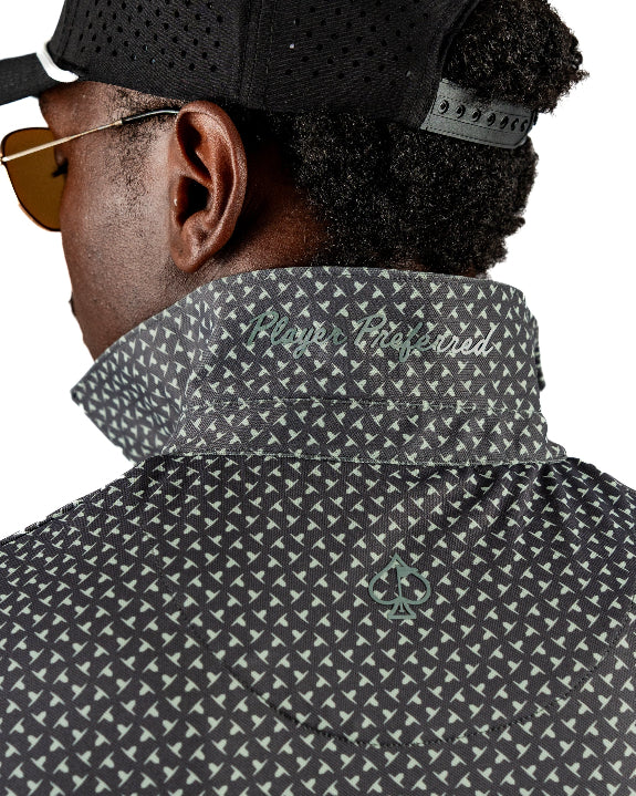 Men’s Jade Drops golf polo by Pins & Aces featuring a dark jade green geometric pattern, modern blade collar, short sleeves, and athletic performance fit.