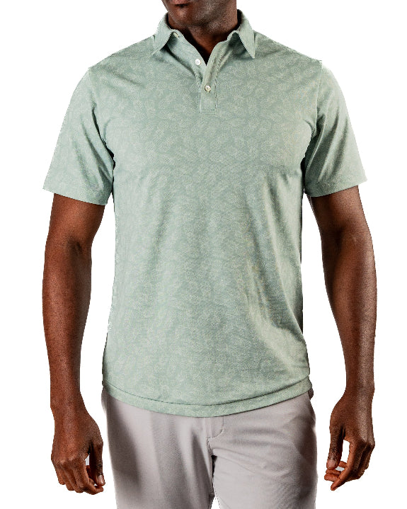 Men’s Pineapples Player Preferred golf polo by Pins & Aces featuring a sage green tonal pineapple print, blade collar, short sleeves, and athletic performance fit.