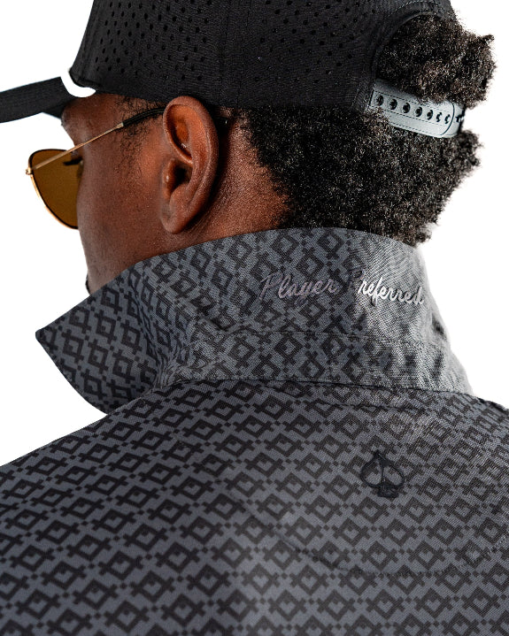 Men’s Slate Mosaic Player Preferred golf polo by Pins & Aces featuring a slate gray geometric pattern, modern blade collar, short sleeves, and athletic performance fit.