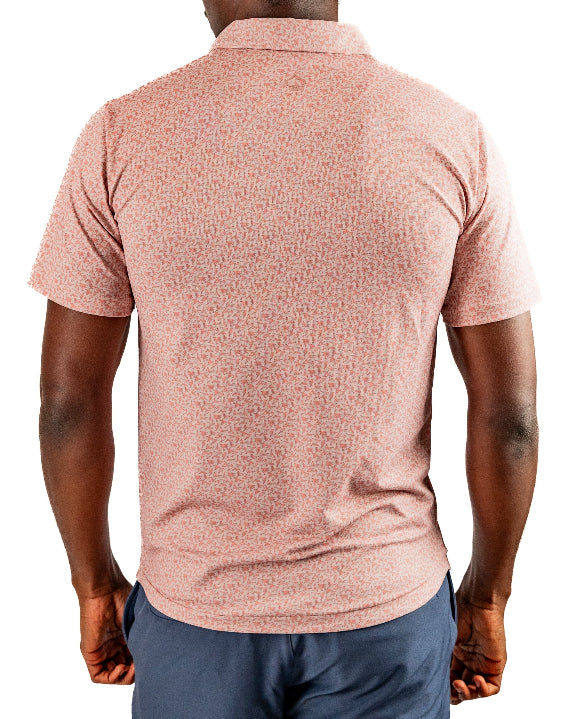 Men’s Sparrows Player Preferred golf polo by Pins & Aces featuring a coral and cream micro-pattern, blade collar, short sleeves, and athletic performance fit.