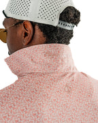 Men’s Sparrows Player Preferred golf polo by Pins & Aces featuring a coral and cream micro-pattern, blade collar, short sleeves, and athletic performance fit.