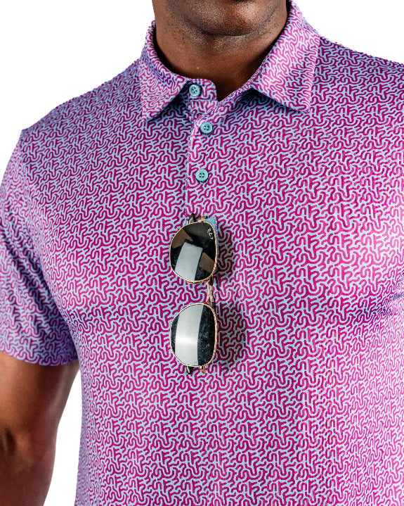 Men’s Sugar Circuit golf polo by Pins & Aces featuring a vibrant pink, purple, and blue geometric all-over pattern with short sleeves and an athletic performance fit.
