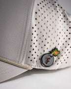 Bone off-white perforated rope golf hat by Pins & Aces featuring breathable perforated panels, braided rope detail, adjustable snapback, and built-in magnetic golf ball marker holder.