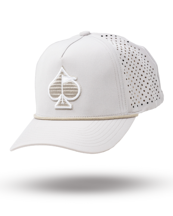Bone off-white perforated rope golf hat by Pins & Aces featuring breathable perforated panels, braided rope detail, adjustable snapback, and built-in magnetic golf ball marker holder.