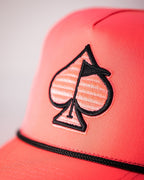Highlighter pink perforated rope golf hat by Pins & Aces featuring an embroidered Fairway Wave Spade logo, adjustable snapback, and built-in magnetic golf ball marker holder.