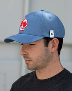 Blue Performance Spade golf hat by Pins & Aces featuring an embroidered Fairway Wave Spade logo, adjustable snapback, curved bill, and built-in magnetic golf ball marker holder.