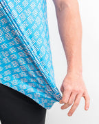 Men’s Skyline Dash Blue golf polo by Pins & Aces featuring a bright blue geometric dash pattern with pink accents and an athletic performance fit.