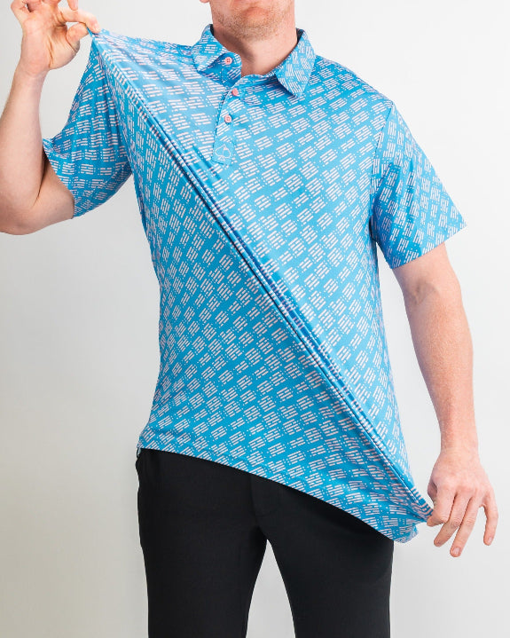 Men’s Skyline Dash Blue golf polo by Pins & Aces featuring a bright blue geometric dash pattern with pink accents and an athletic performance fit.