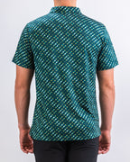 Men’s Chromo Green performance golf polo by Pins & Aces featuring an all-over green, blue, and yellow diagonal geometric stripe pattern with short sleeves and an athletic fit.