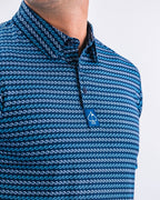 Men’s Rising Tides golf polo by Pins & Aces featuring a repeating blue and navy wave-inspired pattern, short sleeves, and an athletic performance fit.