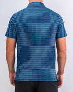 Men’s Rising Tides golf polo by Pins & Aces featuring a repeating blue and navy wave-inspired pattern, short sleeves, and an athletic performance fit.