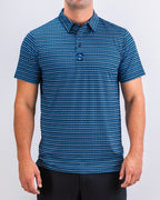 Men’s Rising Tides golf polo by Pins & Aces featuring a repeating blue and navy wave-inspired pattern, short sleeves, and an athletic performance fit.