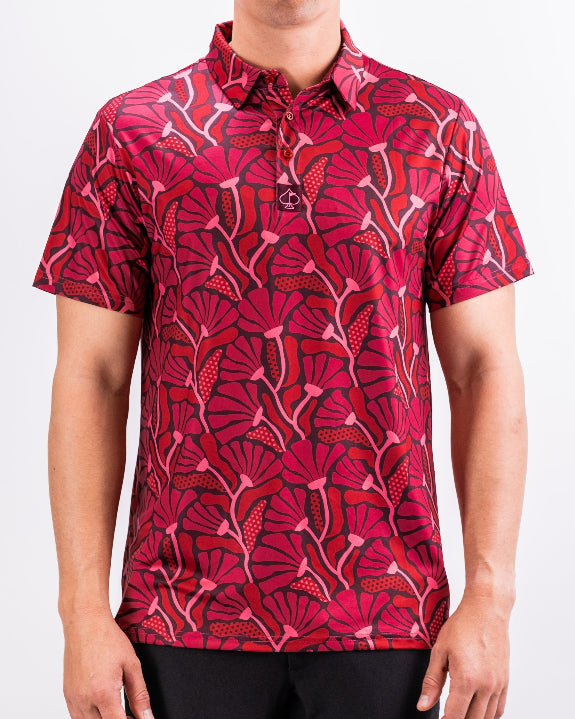 Men’s Garden Party Crimson Bloom golf polo by Pins & Aces featuring an oversized crimson, red, pink, and burgundy floral print with short sleeves and an athletic performance fit.