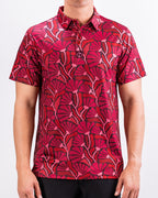 Men’s Garden Party Crimson Bloom golf polo by Pins & Aces featuring an oversized crimson, red, pink, and burgundy floral print with short sleeves and an athletic performance fit.