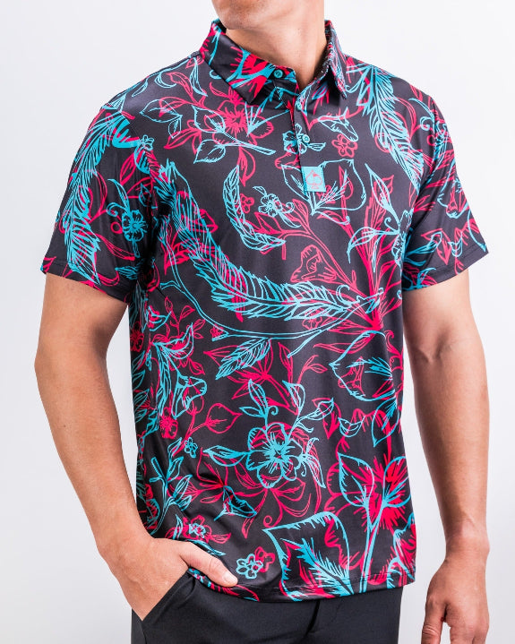 Men’s Cabo Electric golf polo by Pins & Aces featuring an aqua, hot pink, and coral tropical floral and leaf print on a dark charcoal background with an athletic performance fit.