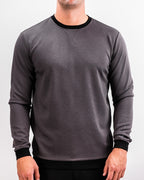 Men’s Player Preferred™ Slate Grey performance golf crewneck by Pins & Aces featuring a classic crew neckline, long sleeves, elastic cuffs and waist, and a tailored course-to-clubhouse fit.