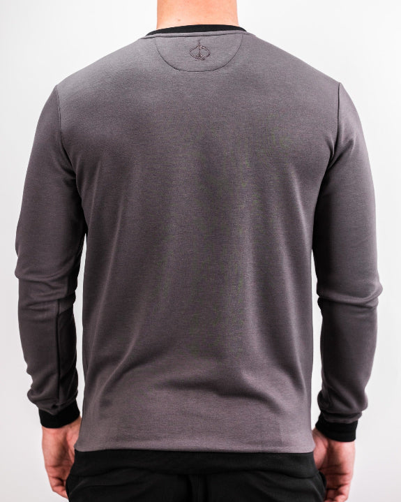 Men’s Player Preferred™ Slate Grey performance golf crewneck by Pins & Aces featuring a classic crew neckline, long sleeves, elastic cuffs and waist, and a tailored course-to-clubhouse fit.