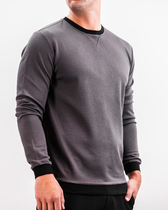 Men’s Player Preferred™ Slate Grey performance golf crewneck by Pins & Aces featuring a classic crew neckline, long sleeves, elastic cuffs and waist, and a tailored course-to-clubhouse fit.